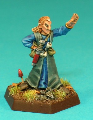 Pose 1. This figure is the low-level character, modelled in a spellcasting pose, wearing a plain tunic and robe, and carrying little more than a belt pouch, a sheathed dagger and a scroll tucked into his belt.
