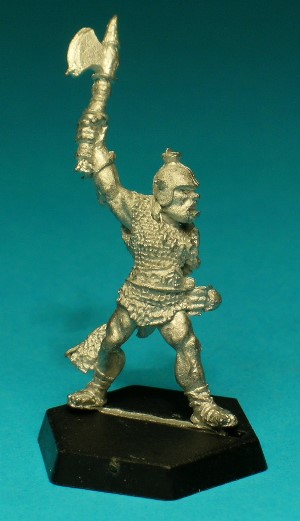 Pose 3, variant A. This figure is armed with a single-bladed, one-handed axe and his left hand has a shield stud. He wears leather sandals, a chainmail shirt and a broad belt from which hangs a longsword in a fur scabbard. He also wears a bone, tooth and claw necklace around his neck. This variant has shoulder-length hair showing beneath a steel helmet with two small horns and a rounded boss on top. His mouth is open in a shout.