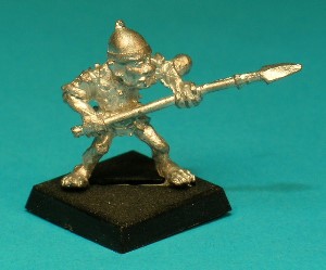 Pose 2, variant C. This variant wears a spiked conical steel helmet with a raised rim, and he is looking along the length of his spear. His closed mouth has protruding upper fangs visible.