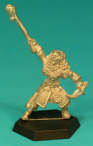 Pose 1, variant E. This variant holds a long dragon-headed sceptre high in her right hand, and has a short-bladed, etched dagger held low in her left. She has long hair held in place by a band with a tall, eloborate leaf-shaped design on the front. Her face looks forwards, with her mouth slightly open.