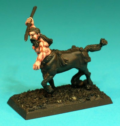 Pose 1, variant F. This variant is a male warrior, preparing to throw a spear held above his head. He wears a large ring in his left ear, and has long hair tied in a ponytail, and a full moustache and long beard. He looks downwards and slightly to his left, as he lines up his spear cast.