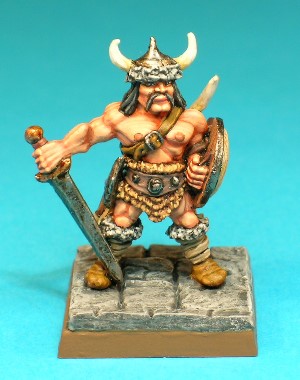 Figure 2, Unarmoured Fighter.<br>This is a Barbarian-type character, unarmoured and wielding a broadsword and a wooden shield. He carries a good range of adventuring gear, including a hand axe, a shortbow, a quiver and a leather sack. He wears fur-lined boots and a horned, fur-trimmed skullcap.