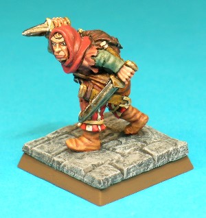 Figure 5, Thief.<br>This Thief figure is armed with a shortsword and a dagger, and he wears a leather jerkin, low boots and a cowled hood. He carries the usual array of adventuring equipment on his back.