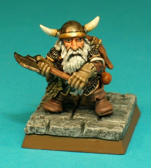 Figure 8, Dwarf.<br>The Dwarf character wears a chainmail shirt and a round, horned helmet. He wields a simple battleaxe and carries a sack, coil of rope, 2 oil flasks, a crossbow and a quiver of bolts.